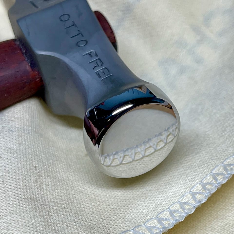 A polished face of a jeweler's hammer